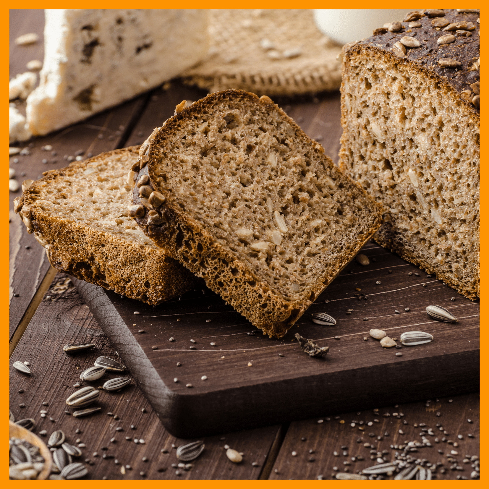 Home 5 Low-carb seed bread loaf with sunflower and chia seeds, sliced on a wooden board.