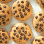 Soft golden-brown chocolate chip cookies on parchment