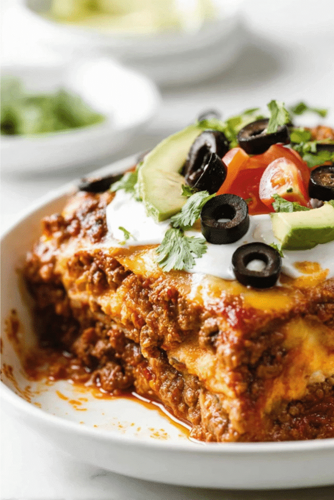 Keto Taco Lasagna: The Ultimate Crave-Worthy Low-Carb Dinner 7 Sliced keto taco lasagna in loaf pan with visible meat layers