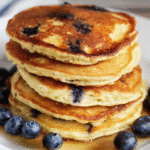 Stack of blueberry pancakes with syrup from a protein pancakes recipe.