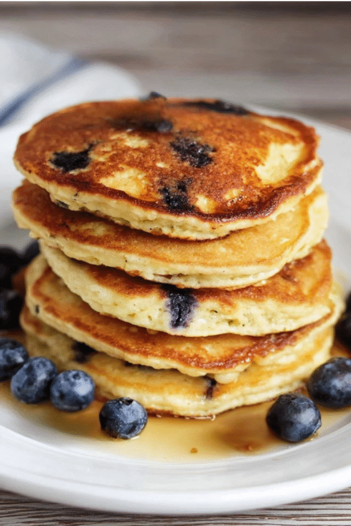 Protein Pancakes Recipe: Quick, Fluffy & Low-Carb Breakfast Win 1 Stack of blueberry pancakes with syrup from a protein pancakes recipe.