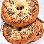 Low carb bagels with everything seasoning on a white towel, vertical format
