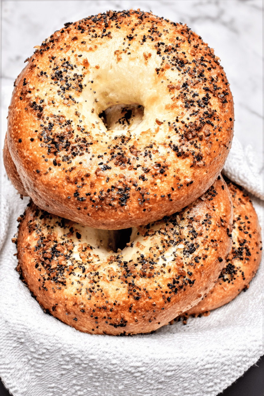 Low Carb Bagels Recipe – A Perfect Start to the Day 2 Low carb bagels with everything seasoning on a white towel, vertical format