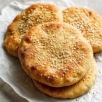 Freshly baked keto pita bread with sesame seeds on parchment