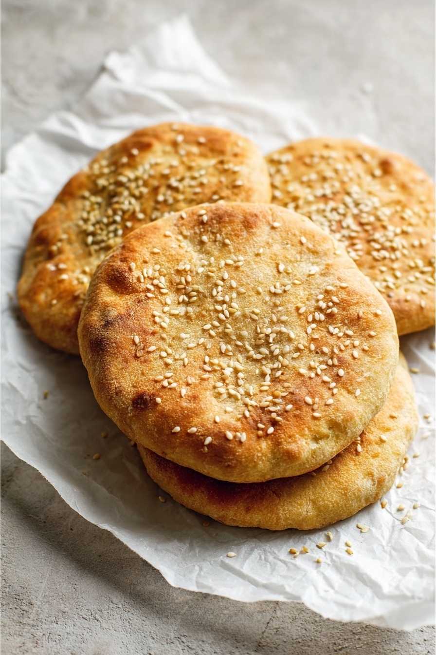 Keto Pita Bread Recipe That’s Fluffy, Easy & Low-Carb 2 Freshly baked keto pita bread with sesame seeds on parchment
