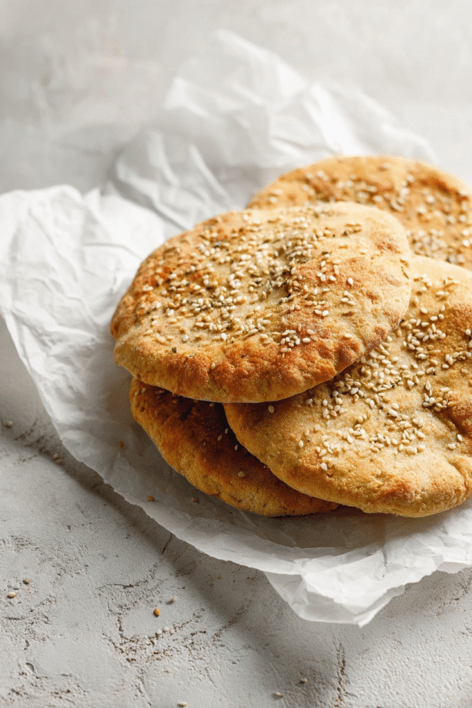 Keto Pita Bread Recipe That’s Fluffy, Easy & Low-Carb 1 Stack of rustic golden keto pita bread with sesame seeds