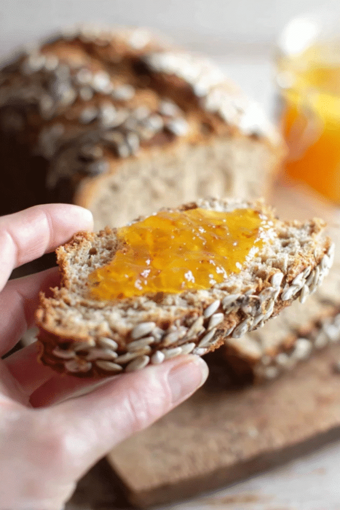 Low Carb Bread That Tastes Like the Real Thing 4 Hand holding a slice of low carb bread with sugar-free jam
