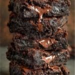 Stack of fudgy Greek yogurt brownies with melted chocolate